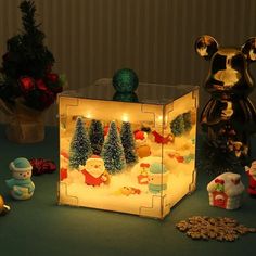 a lighted box with christmas decorations and lights on the inside is surrounded by other ornaments