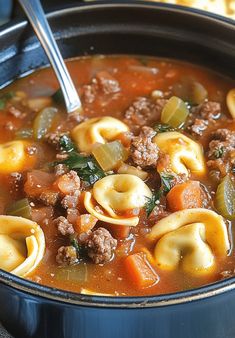 a pot filled with pasta and meat soup