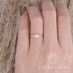 a woman's hand with a diamond ring on top of her left hand and the word starlandus written across it