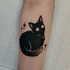 a black cat tattoo on the left forearm and right arm, with stars around it