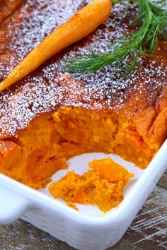 a casserole dish with carrots and powdered sugar on the top is ready to be eaten