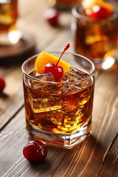 an old fashioned cocktail with orange and cherries