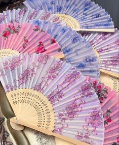 several different colored fan sitting on top of each other