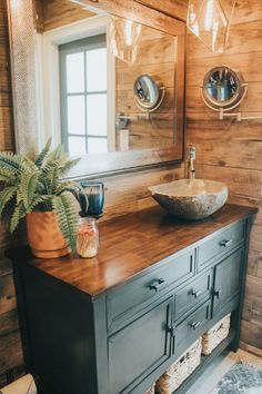 a bathroom with a sink and wooden walls