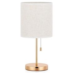 a gold table lamp with a white shade