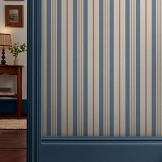 a blue door with striped wallpaper on it