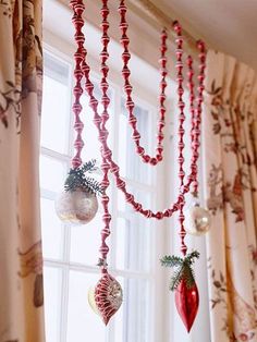 some ornaments hanging from a window sill