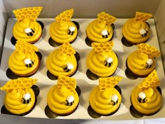 twelve cupcakes with yellow frosting decorated like bees