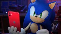 sonic the hedgehog holding an iphone in his hand