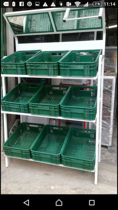 the shelves are filled with green plastic baskets