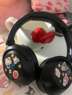 two hello kitty headphones sitting on top of a table