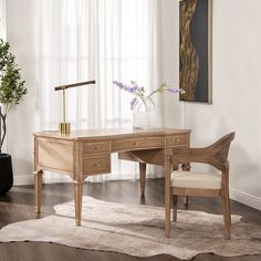 a wooden desk and chair in front of a window