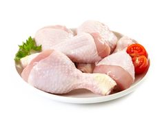 raw chicken legs on a plate with tomatoes and parsley stock photos, royalty images