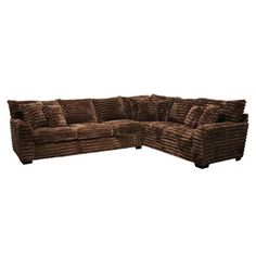 a brown sectional couch with pillows on it's back and the seat folded out