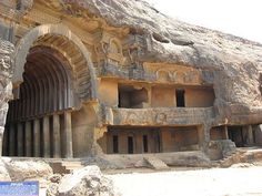 the entrance to an ancient cave with carved carvings on it's walls and pillars