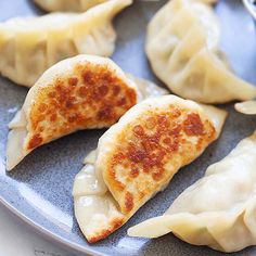 some dumplings are sitting on a blue plate