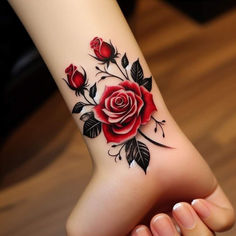 a woman's foot with a rose tattoo on it