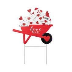 a red wheelbarrow with lots of love mail on it and hearts sticking out of the top