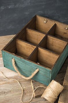 an old wooden box with rope on the table