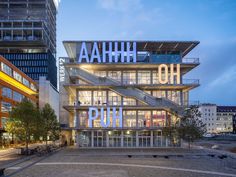 the entrance to an office building with stairs leading up to it's top floors