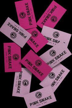 pink snake tickets are scattered on top of each other