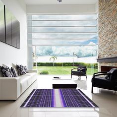 a living room with white couches and red rug