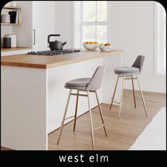 a kitchen with two stools next to the counter