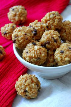 a bowl filled with oatmeal and raisins next to a red towel