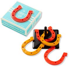 a pair of orange and yellow horseshoes sitting next to a box of soapy up