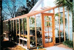 a small greenhouse with lots of plants growing inside