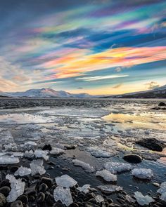 the sky is filled with colorful clouds and ice