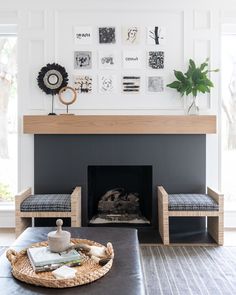 a living room with a fireplace and pictures on the wall