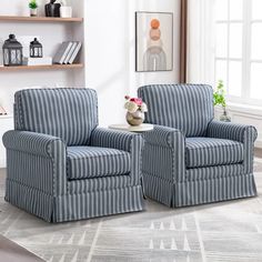 two blue striped chairs sitting next to each other on a rug in front of a window