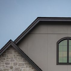 an image of a window on the side of a house that is gray and black