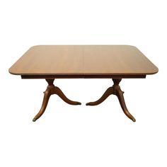 a wooden table with two leaves on the legs and an oval shaped center piece at the top