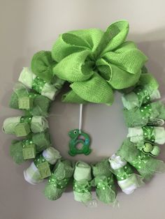 a green wreath is hanging on the wall