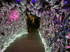 the walkway is decorated with purple and silver balloons