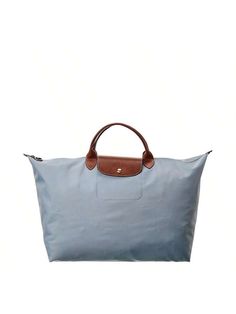 Introducing the Longchamp Le Pliage Large Canvas Top Handle Tote, a symbol of sophistican and timeless elegance. Made by the renowned brand Longchamp, known for its understated luxury leather goods with a French touch, this tote bag is the perfect accessory for women who value both style and funcnality.Crafted with steel canvas and accentuated with brown leather, this tote bag exudes a modern yet classic vibe. The gold-tone hardware adds a touch of glamour, elevating its over design. Its spauser Longchamp Le Pliage Large, Classic Vibe, Large Canvas, Longchamp Le Pliage, Leather Goods, Luggage Bags, Top Handle, Bags Women, Timeless Elegance