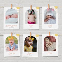 four baby pictures hanging on clothes pins in front of a brick wall