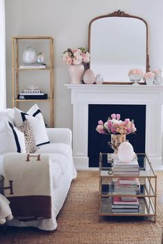 a living room filled with furniture and a fire place in front of a white fireplace