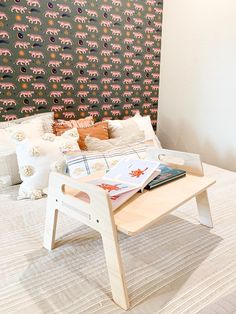 a bed with an animal wallpaper behind it and a coffee table in front of it