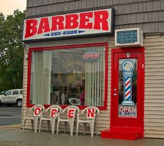 a barber shop with chairs outside the window