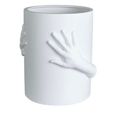 a white vase with a hand on it