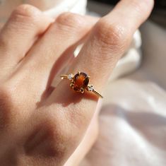 The Oval Citrine Sunrise ring features a natural orange oval citrine center stone. A ring to remind you of the beauty of a sunrise. Handcrafted in your choice of gold vermeil, or 14K solid gold. Also, comes with a diamond and moissanite center stone here. Gold vermeil or 14k solid gold 8x6mm natural oval Citrine Round CZs (what's this?) 1.2mm ring band ** This item is specially made for you. Please allow 1-2 week lead time. ShippingDomestic: Free standard shipping within the U.S.International: F Ring Ding Dong, Minimalist Engagement Ring, Citrine Jewelry, Minimalist Rings, Ring Band, 925 Sterling Silver Ring