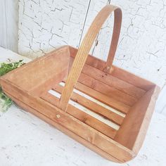 a wooden basket sitting on top of a table