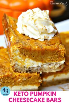 keto pumpkin cheesecake bars stacked on top of each other and topped with whipped cream