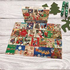 the christmas card game is open and ready to be played on the wooden table with green ribbon