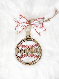 a baseball ornament hanging on a white fur surface