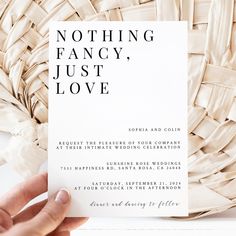 a person holding up a card with the words nothing fancy, just love on it