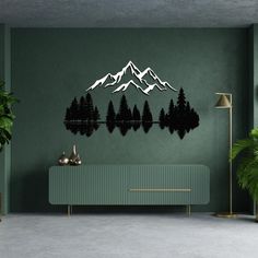 a living room with green walls and mountains on the wall